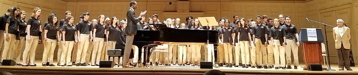 <p>Holocaust survivor Michael Gruenbaum (far right) joins the Boston Children’s Chorus for a rendition of “Brundibar,” which he sang in 1943.</p>