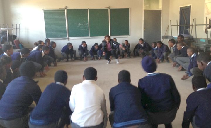 Lorato, Young 1ove’s Training Officer, energizes a group of students during programming