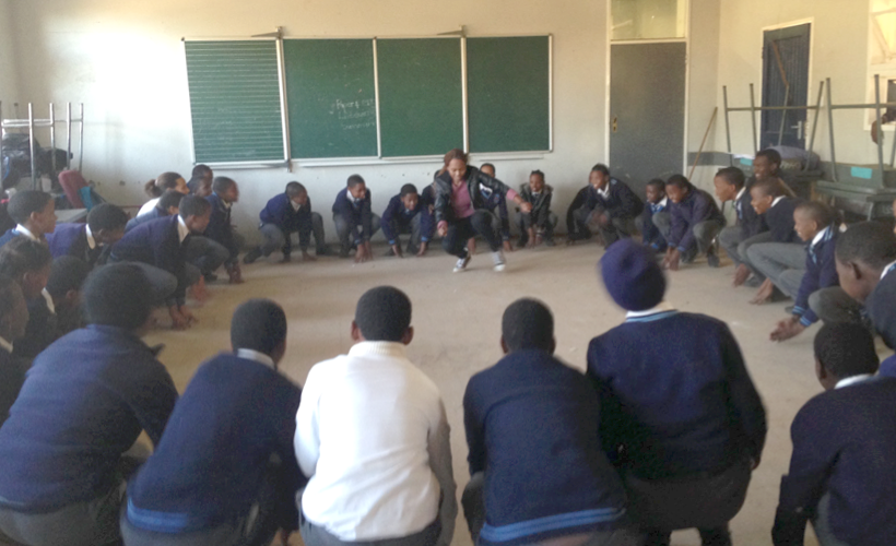 <em>Lorato, Young 1ove’s Training Officer, energizes a group of students during programming</em>