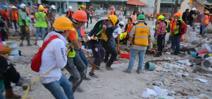 Volunteers work in the wreckage of a demolished building after the recent Mexico City earthquake.