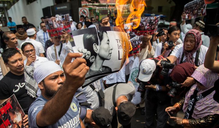 An Indonesian protester burns a picture of Suu Kyi during a rally in front of the Myanmar embassy in Jakarta on Sept. 2.