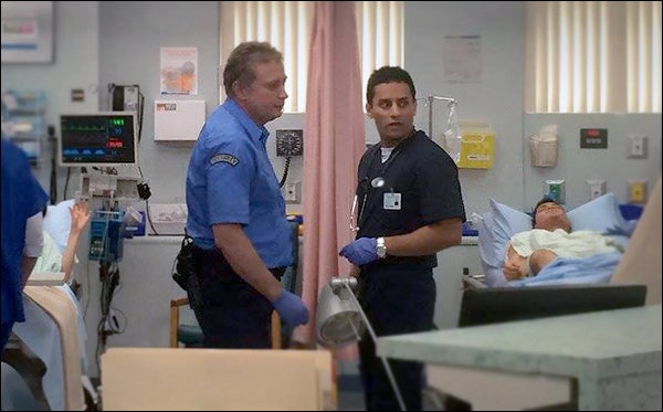 Dr. Sudip Bose (foreground, right) talks with a first-responder in the Emergency Department. 