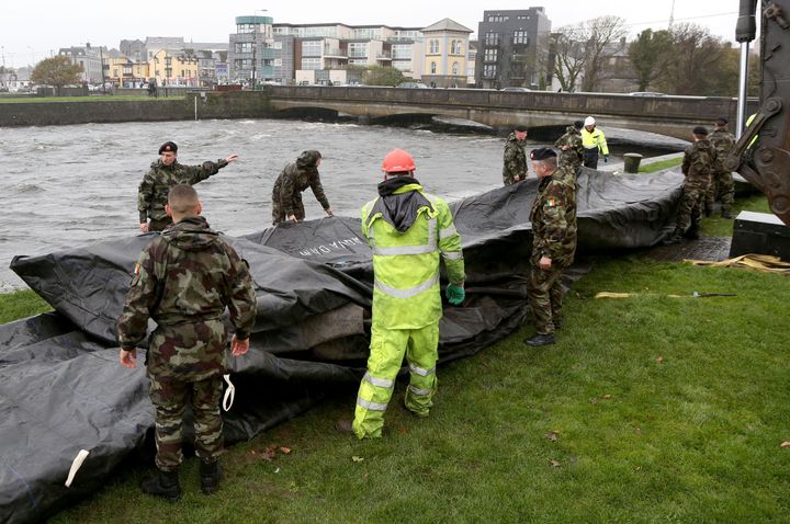 People across the UK and Ireland have been preparing for Storm Brian to hit. In Galway City (pictured) flood barriers are readied for the 'weather bomb'. 