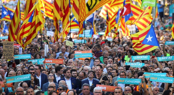 Puigdemont and other Catalan regional government members attend a demonstration organized by Catalan pro-independence movements in Barcelona on Oct. 21.