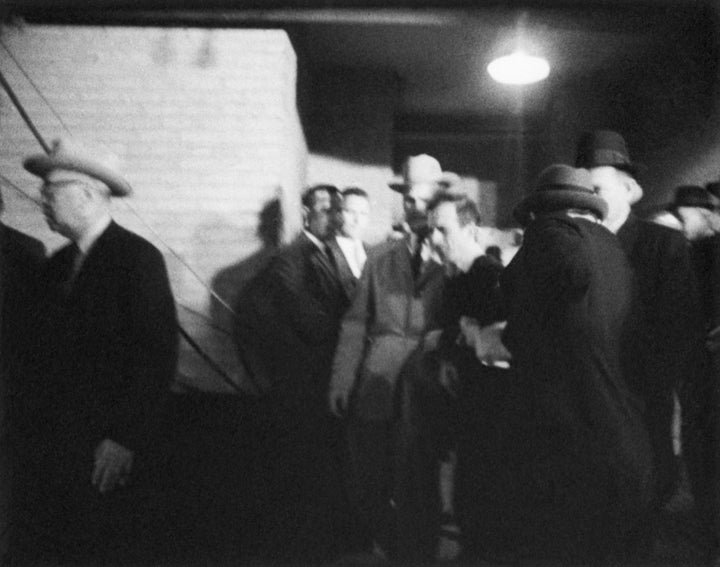 Jack Ruby walks up to accused presidential assassin Lee Harvey Oswald and shoots him as he is escorted into a police station in Dallas.