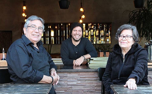 <p><strong>Peter with his parents, John and Litsa.</strong></p>