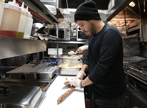 <p><strong>Peter preparing the sausage.</strong></p>