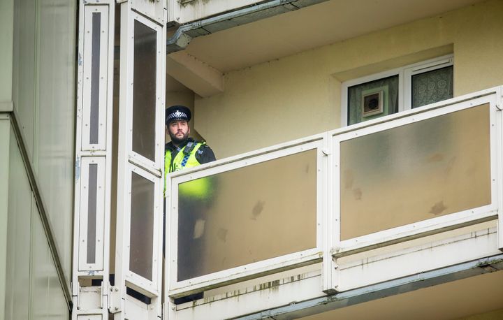 A police officer on a balcony at Newcastle House in Bradford, where 18-month-old Elliot Procter died following a fall from a sixth-floor window