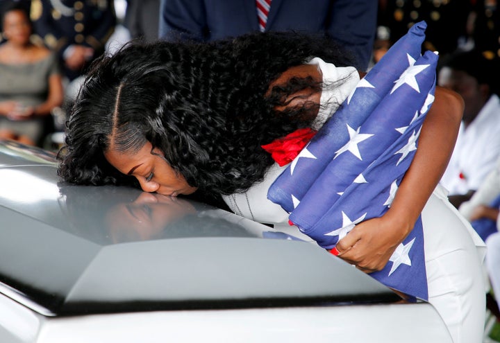 Johnson kisses her late husband's coffin at a graveside service in Hollywood, Florida, October 21, 2017. 