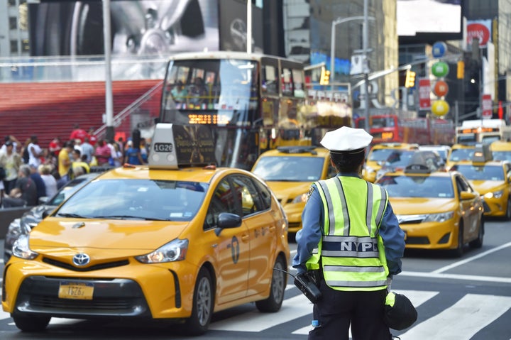 A police officer controls the traffic in Times Square, downtown Manhattan. 