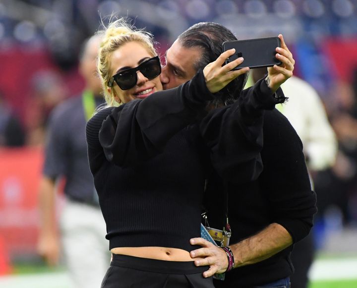 Lady Gaga gets a kiss from Christian Carino before Super Bowl LI.