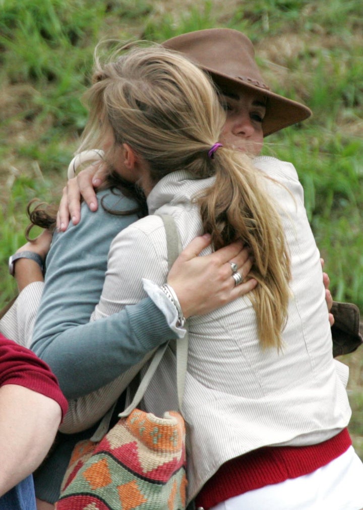 Kate Middleton, then-girlfriend of Prince William, hugs a friend on the second day of the Gatcombe Park Festival on August 6, 2005 near Tetbury, England.