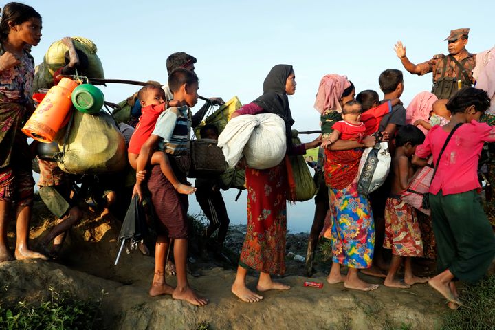 Rohingya refugees arrive to the Bangladeshi side of the Naf river after fleeing Myanmar.