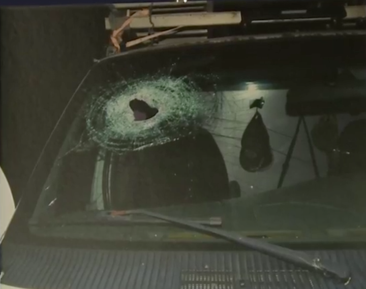 This photo shows a hole left in the windshield of a car that Kenneth Andrew White had been riding in at the time of his
