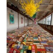 The 85-foot dining table in The Boathouse serving some of Dale Chihuly’s thousands of matchbooks. Chandeliers and paintings