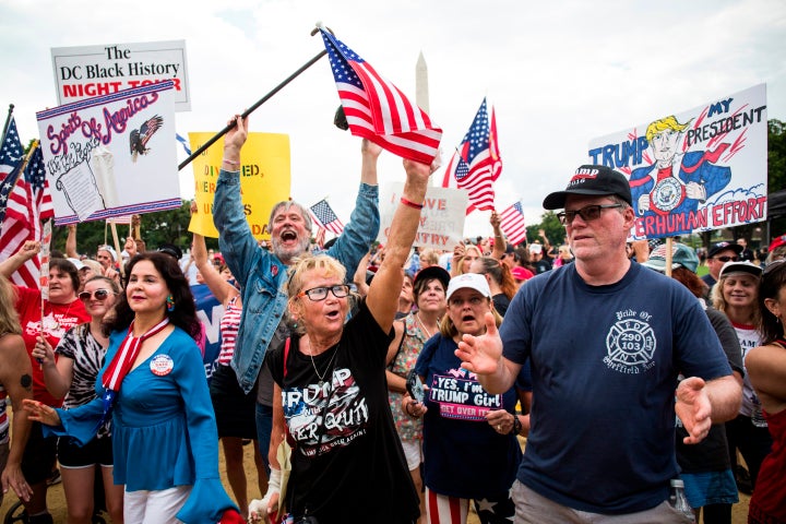 Demonstrators wave national flags and placards during the pro-Trump 'Mother of All Rallies' on the National Mall in Washington, DC on September 16, 2017.