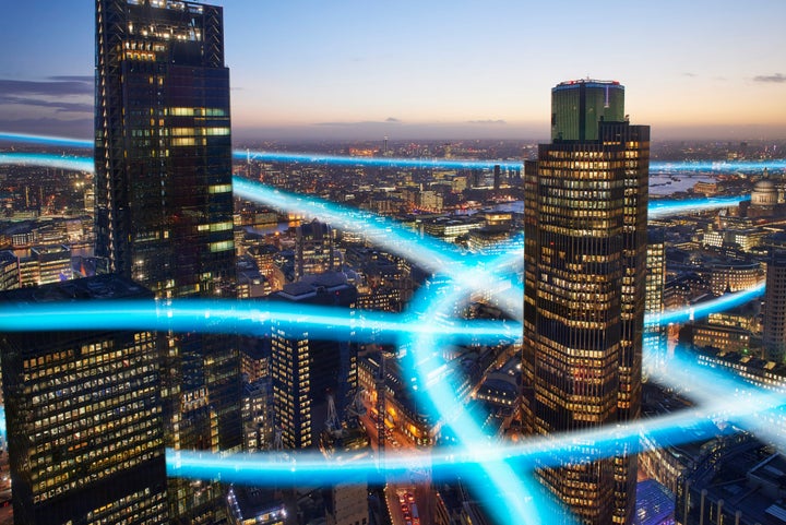 City of London business district with light trails. John Lamb via Getty Images