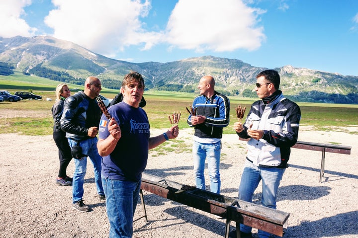 Bikers enjoying arrosticini at Ristoro Mucciante in Gran Sasso e Monti della Laga National Park