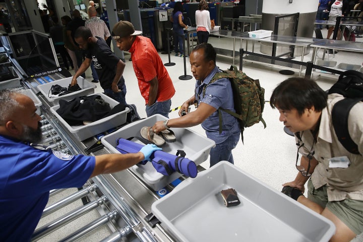 Travelers use automated screening lanes at Miami International Airport 