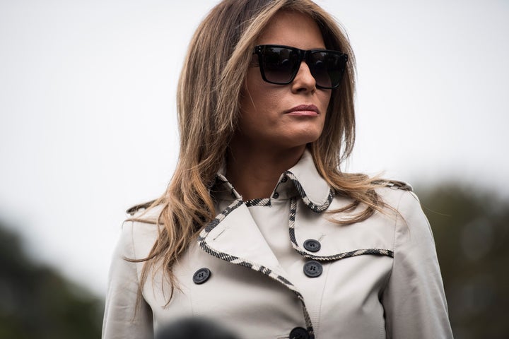 First lady Melania Trump listens as the president speaks to reporters on the South Lawn of the White House in early Octo