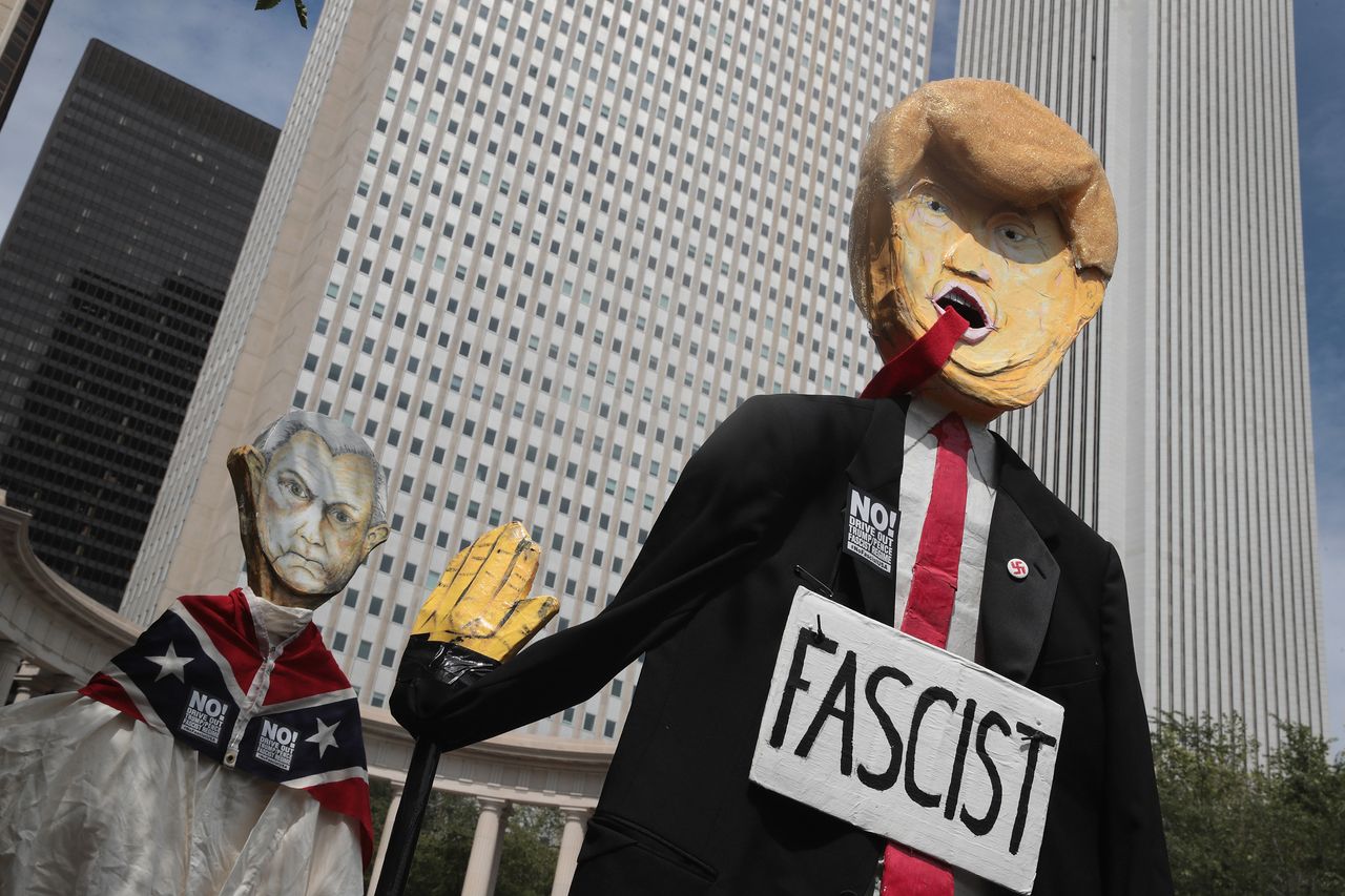 Demonstrators in Chicago protesting the alt-right and mourning Charlottesville, Virginia, victims carry puppets of President Donald Trump and U.S. Attorney General Jeff Sessions on Aug. 13.