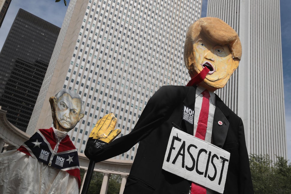 Demonstrators in Chicago protesting the alt-right and mourning Charlottesville, Virginia, victims carry puppets of President 