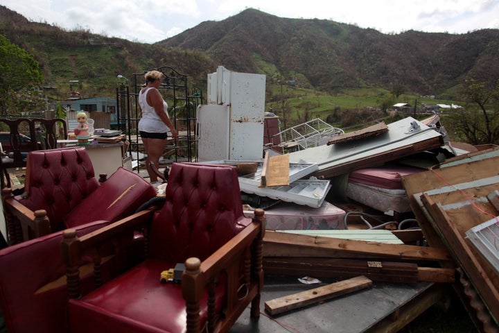 Haydee Mestre looks inside her refrigerator after Hurricane Maria destroyed the town's bridge and the surrounding areas, in San Lorenzo, Morovis, Puerto Rico, October 5, 2017.