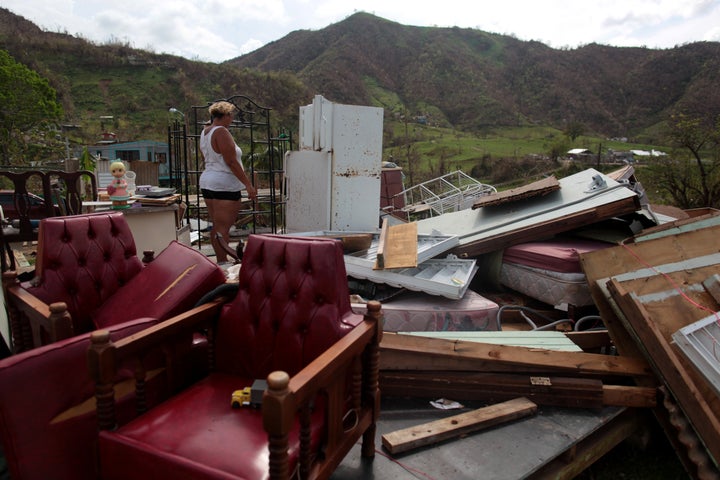 Haydee Mestre looks inside her refrigerator after Hurricane Maria destroyed the town's bridge and the surrounding areas, in San Lorenzo, Morovis, Puerto Rico, October 5, 2017. 