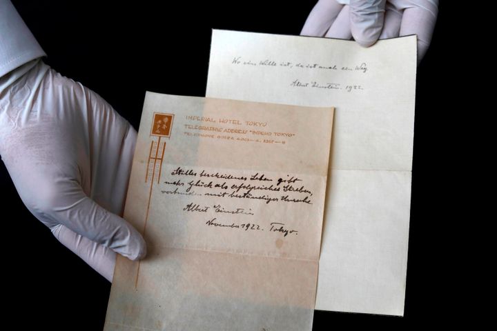 Gal Wiener, owner and manager of the Winner's auction house in Jerusalem, displays two notes written by Albert Einstein