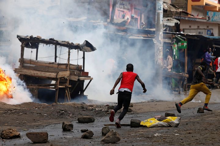 Protesters supporting opposition leader Raila Odinga, run away from police in the slum area of Mathare in the capital Nairobi, Kenya. 
