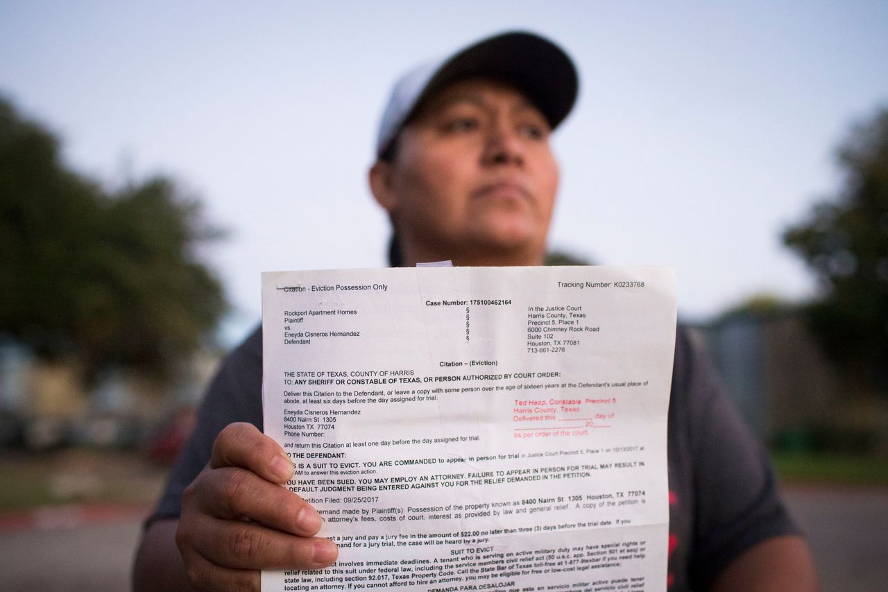 Eneyda Cisneros Hernandez holds an eviction citation she received from Rockport Apartments, the complex where she lives in Houston. 
