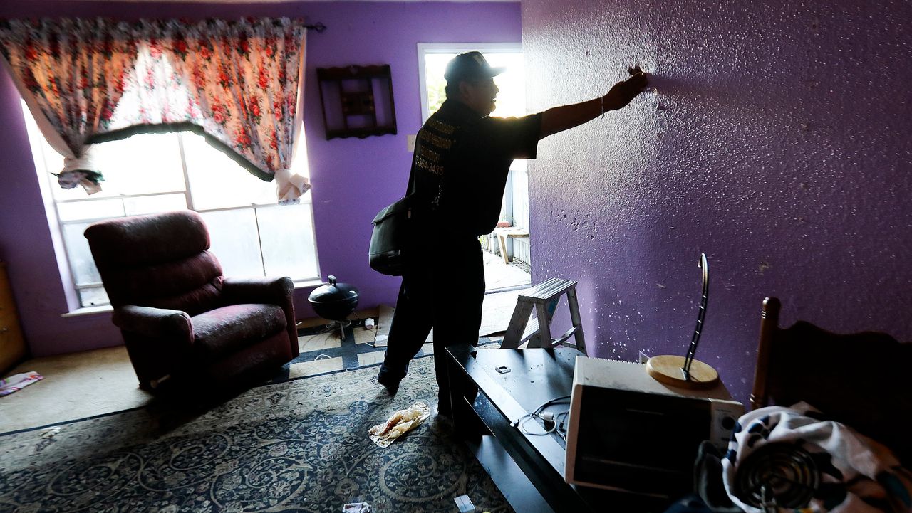 Community organizer Alain Cisneros easily puts his hand through a soaked wall in a Rockport Apartment that was damaged by Tropical Storm Harvey on Thursday, Sept. 7, 2017, in Houston.