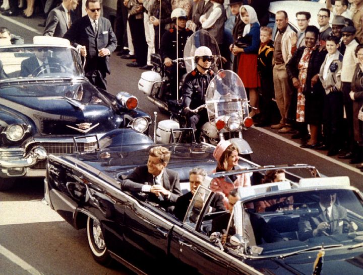 President Kennedy and his wife ride through Dallas moments before the assassination 