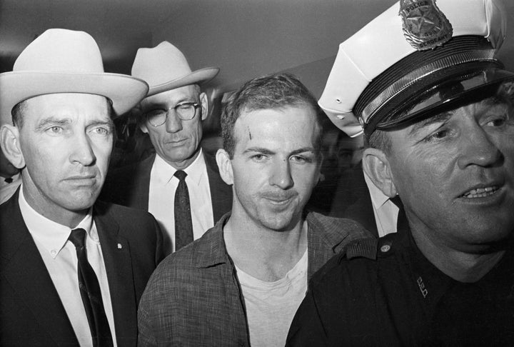 Twenty-four-year-old ex-marine Lee Harvey Oswald is shown after his arrest here on November 22. He received a cut on his forehead and blackened left eye in scuffle with officers who arrested him. 