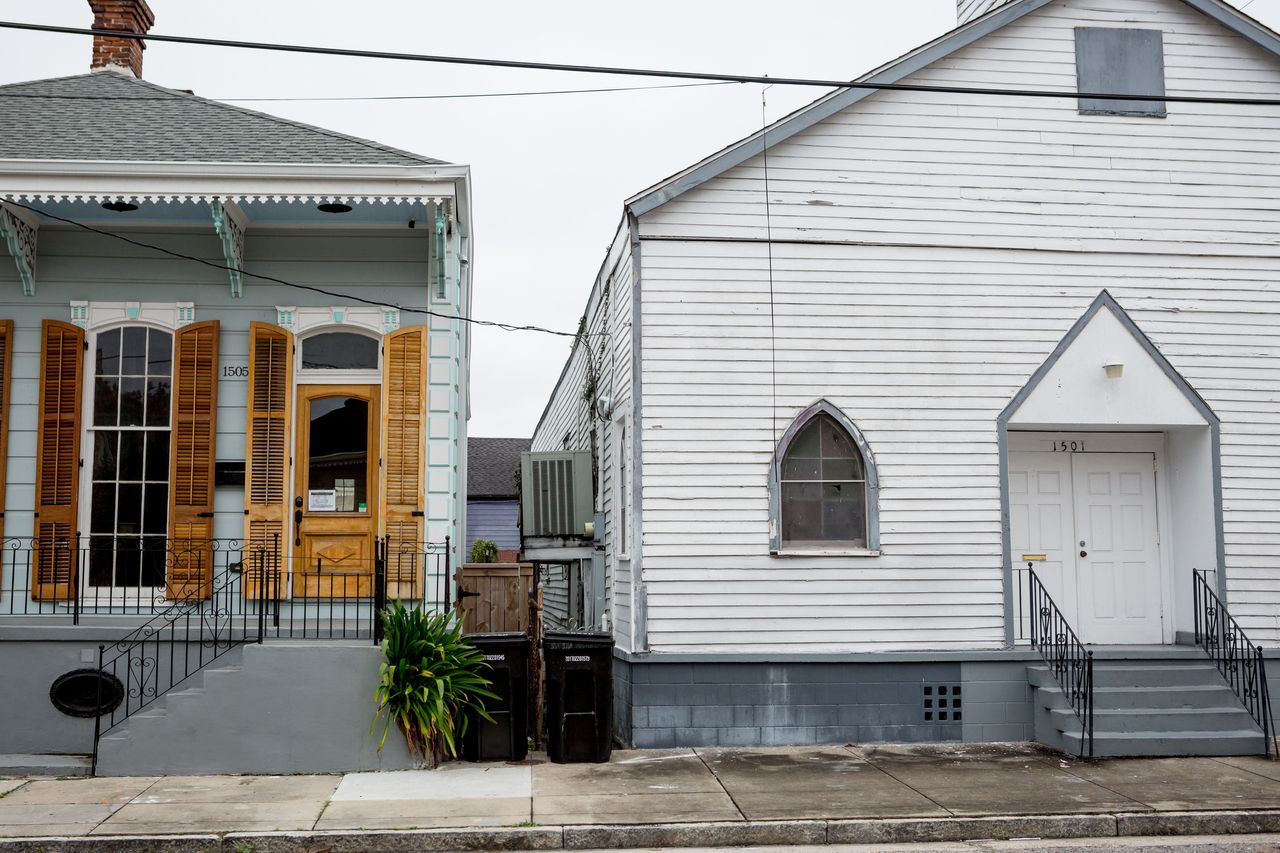 One of Treme's whole-home rentals (left) stands next to a neighborhood church.