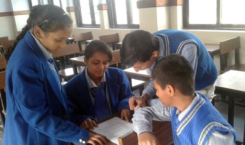 Student participants at a school in New Delhi, India, prepare to read the UHDR in Hindi (Source: UHRI)