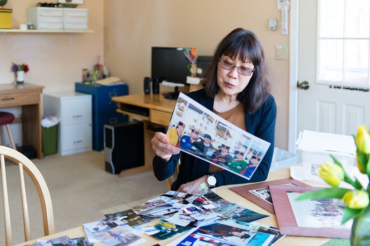 <p>Patricia Martin looks through old photographs of her husband on April 14. Bob Martin, a family practice physician, died in 2014.</p>
