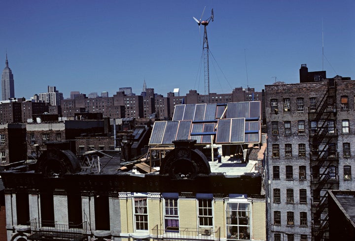 A renovated apartment building with solar panels and a wind-powered generator on New York City's Lower East Side.