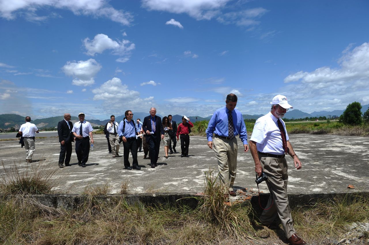 U.S. constructors' representatives, diplomats and reporters tour a dioxin-contaminated at Danang airport. 