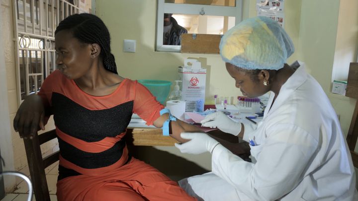 An assistant at the Etoug-Ebe Baptist Hospital, a subsidiary of the Cameroon Baptist Convention Health Services, takes a blood sample of a patient participating in the Novartis Access program to fight non-communicable disease. 