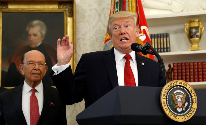 Commerce Secretary Wilbur Ross stands behind President Donald Trump, who speaks at the Minority Enterprise Development Week White House awards ceremony on Oct. 24.