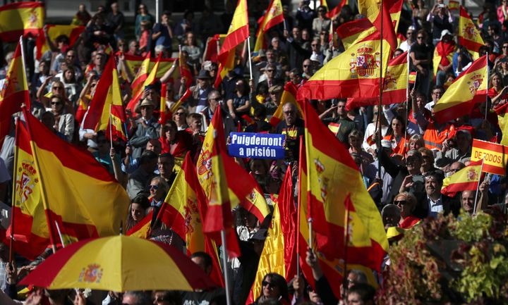 Pro-unity demonstrators gather with a sign calling for the imprisonment of sacked Catalan President Carles Puigdemont in Madrid