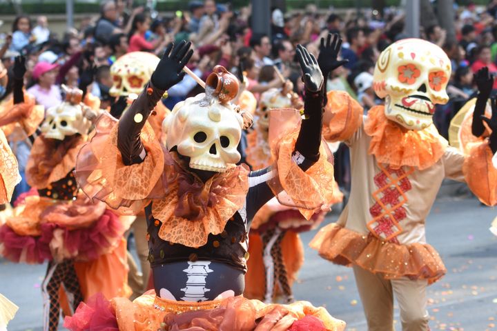 People are seen participating in a Skulls Parade as part of Day of the Dead celebrations in Mexico City on Saturday.