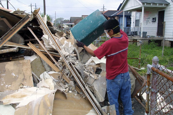  New Orleans, Louisiana, USA - March 20, 2006: A university student on Spring Break helps gut an abandoned house in the Lower Ninth Ward. The Lower Ninth Ward was devastated by the storm and remains a shadow of its former self. 