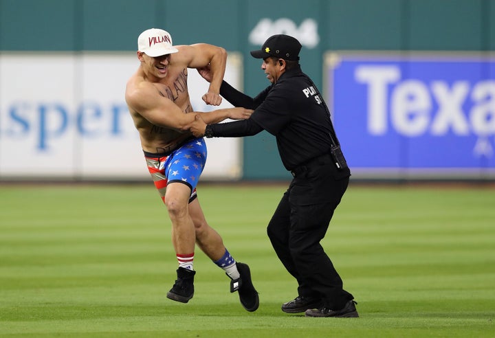 Security apprehends a man during Game 5 of the 2017 World Series between the Houston Astros and the Los Angeles Dodgers on Oct. 29, 2017, in Houston, Texas.