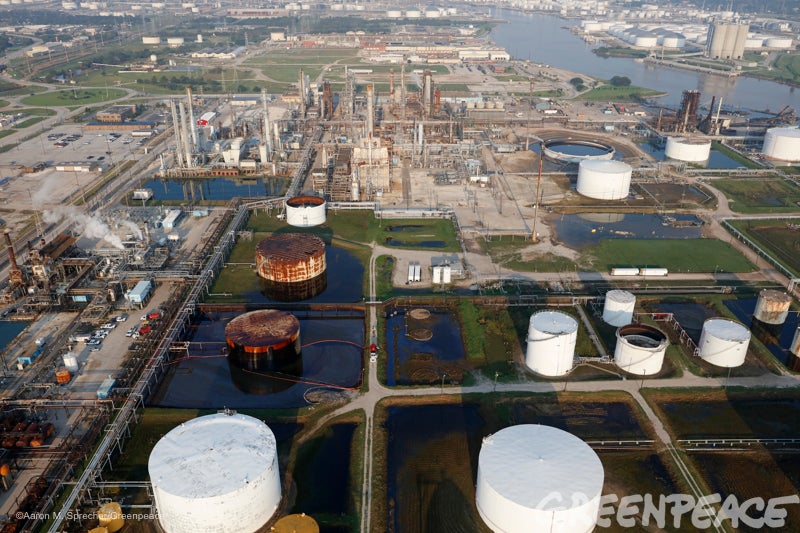 A crew tries to contain oil from a damaged oil refinery storage tank in La Porte, Texas more than a week after Hurricane Harv