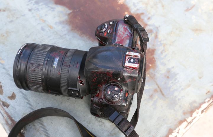 The blood stained camera of a photojournalist is seen in front of Dayah hotel in Somalia's capital Mogadishu, on Jan. 25.