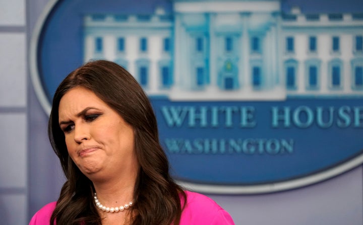 White House press secretary Sarah Huckabee Sanders walks from the lectern after Monday's White House press briefing, in which
