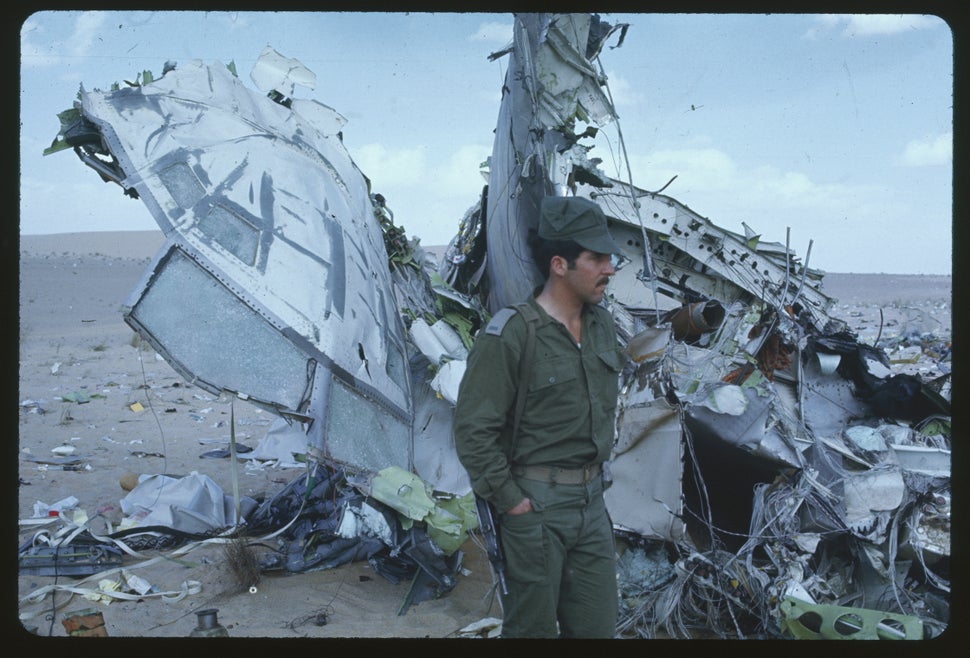 An Israeli soldier stands guard over the charred wreckage of the Libyan Airlines 727 here. The plane was downed by Isreali je