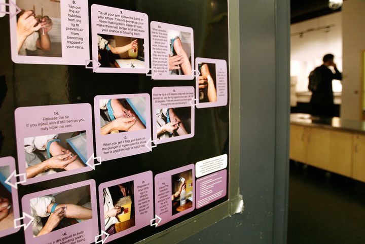 A poster shows how to use a syringe safely inside a safe injection site in Vancouver, Canada, on Aug. 23, 2006.